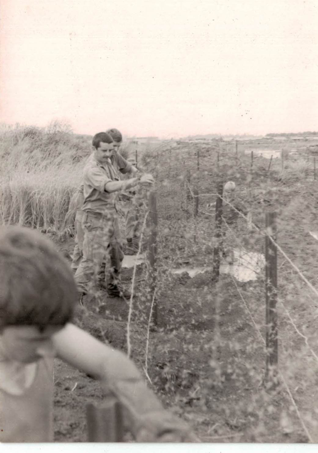 Sappers of 1 FD SQN GP repairing perimeter wire at Nui Dat 1971.